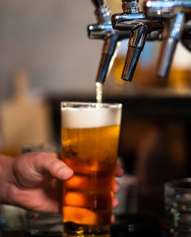 Beer poured into pint glass